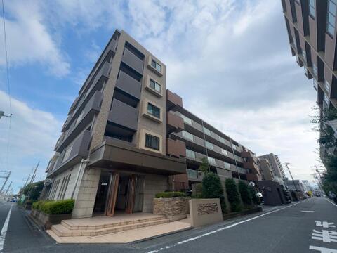 モダンなデザインが魅力のマンション外観。陽光が降り注ぐ明るい街並みで、家族の笑顔が溢れる新生活を始めませんか。