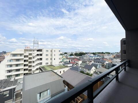 上層階バルコニーから大きく広がる、どこまでも続く青空と街並みを見渡せる開放的なパノラマ眺望。目の前を遮る高い建物がないためプライバシーを守りやすく、毎日の暮らしに圧倒的な心地よさと爽快感をもたらします