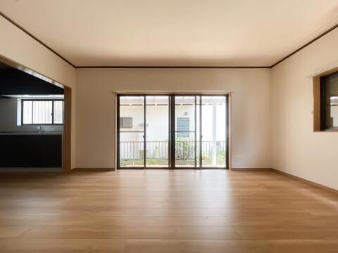 庭へと繋がる大きな窓から心地よい風が吹き抜けるリビング。明るい陽光に包まれてゆったり寛げる空間。