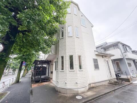 特徴的なデザインの白い外壁が目を引く、スタイリッシュな佇まい。緑豊かな街路樹が並ぶ通りに面し、落ち着いた住環境で家族の毎日を彩ります。