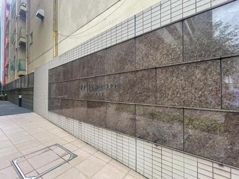 御影石の壁面に輝く館銘板。落ち着いた邸宅の風格漂うエントランスウォールです。