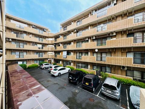 重厚感のある鉄筋コンクリート造のマンション。敷地内には平置き駐車場も設けられています。