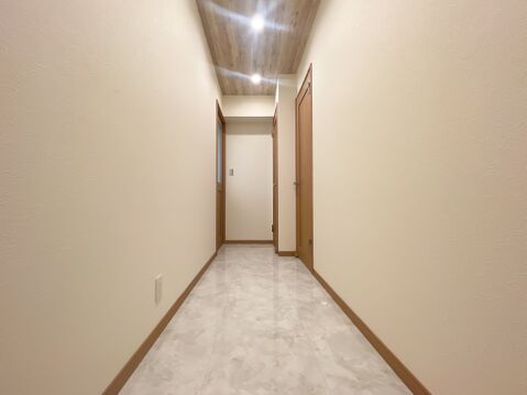 石目調フロア&木目アクセント天井!住まいの顔となる洗練された廊下空間。