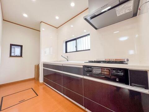 落ち着いたシックな木目調デザイン。窓付きで明るく換気も快適なシステムキッチン