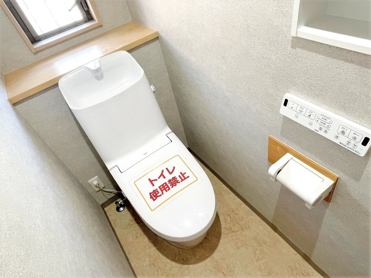 【トイレ/1階】温水洗浄便座付きトイレが採用されています。小物や写真などを飾ることができる棚が設けられています。