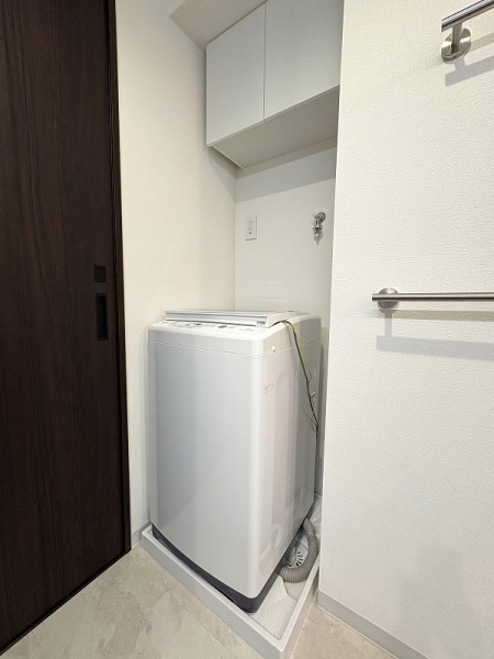 洗濯機置き場には防水パンと天井付近に戸棚がございます。