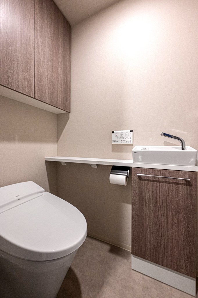【トイレ】トイレットペーパーのストック置きに便利な収納付きです。トイレ内に手洗い器が設置されているので、使用後すぐに手が洗えて衛生的です。