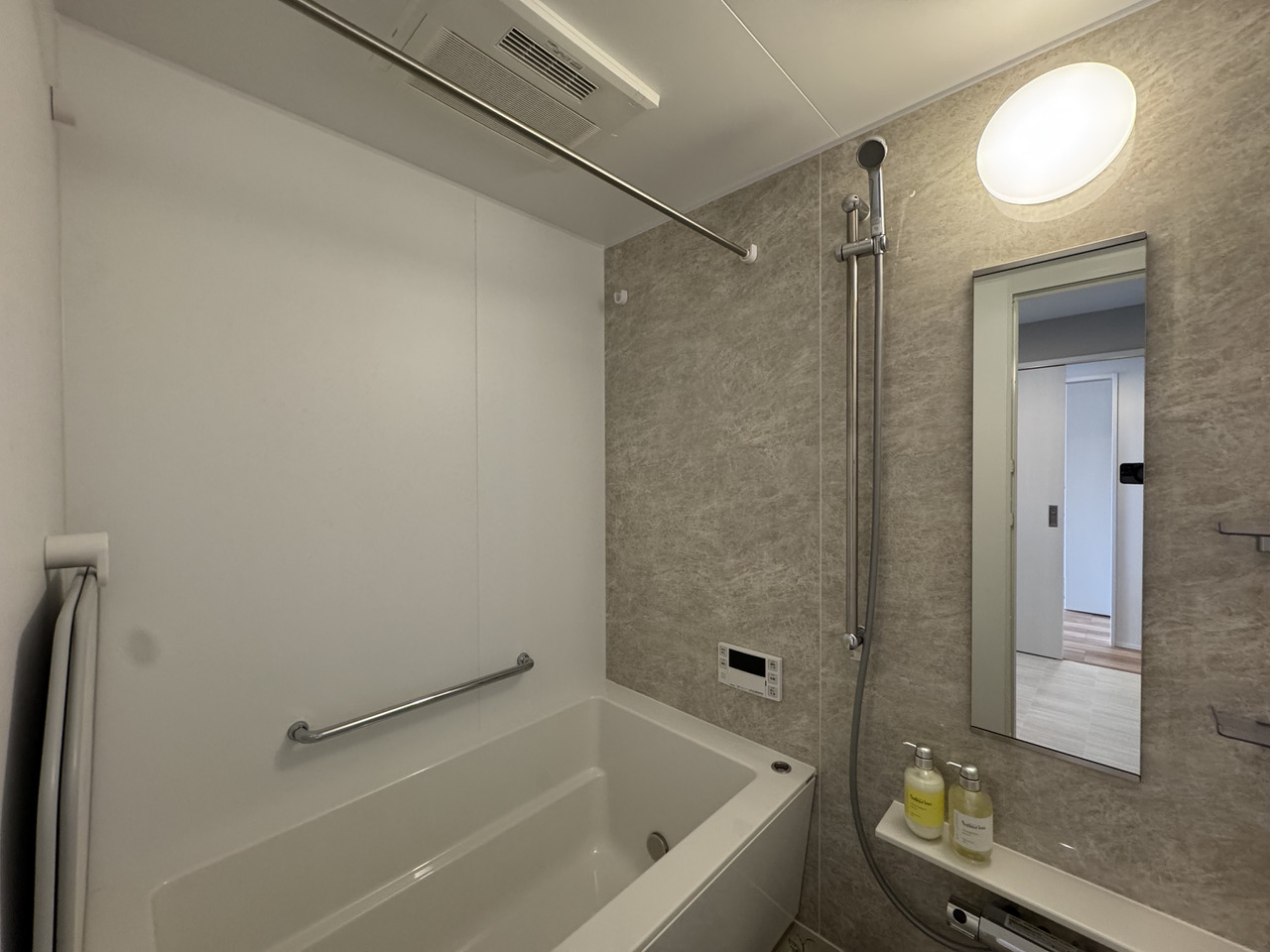 【浴室】浴室換気乾燥機・ハンガーパイプ付きのため、天候や季節に左右されず洗濯物を乾かすことが可能。姿見や手すりの他、シャンプー類を置くことができる棚が設置されています。