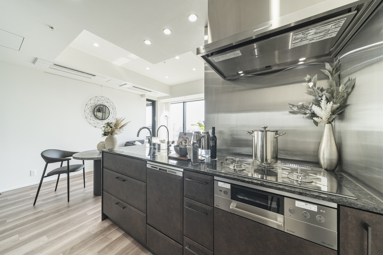 【キッチン】グリル付き3口コンロが備わった対面式キッチン。食器洗乾燥機やディスポーザー付きで、家事をサポートしてくれます。※家具・調度品等は販売価格に含みません。