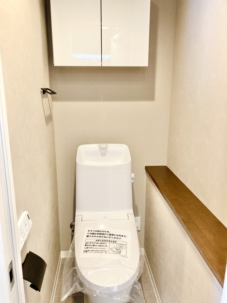 【トイレ】快適にご使用いただける、温水洗浄便座付きのトイレです。芳香剤や、お好みの小物を置くことができる棚も備えられています。