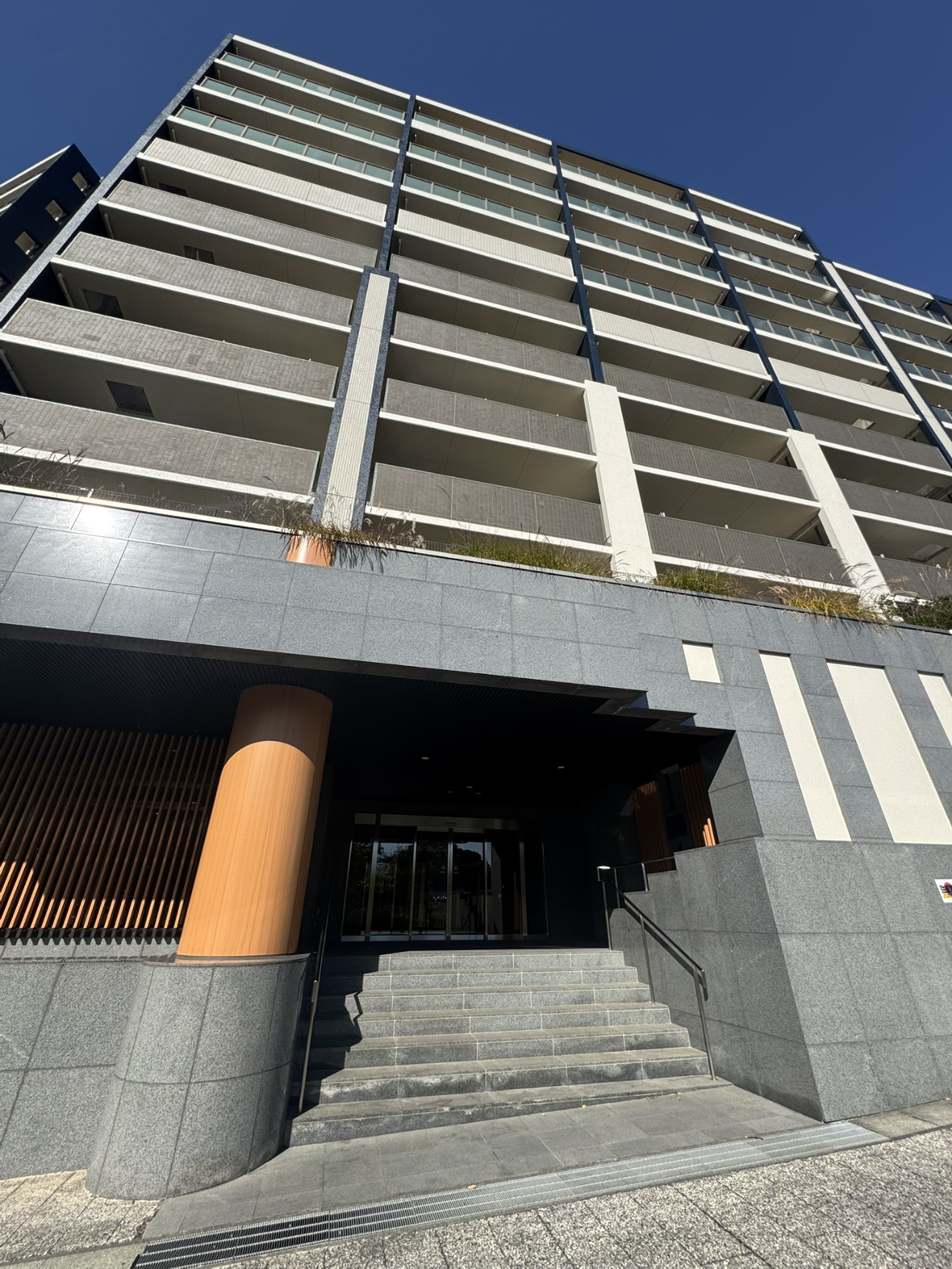 【エントランス】シンプルでスッキリとしたデザインの外観。屋根付きのエントランスなので、雨の日もスムーズに雨具の準備を進められます。