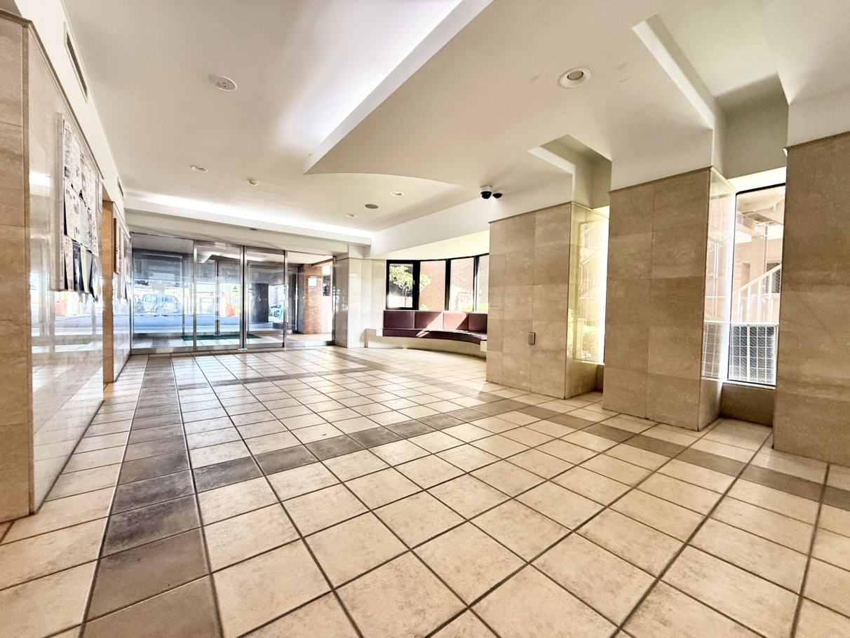 【エントランス】開放的なエントランス。ソファーが設置され、ご家族との待ち合わせなどにも活用できます。壁面には掲示スペースがあります。