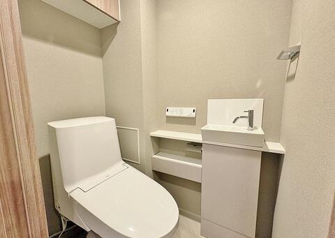 清潔感あふれるトイレは、独立した手洗い器と収納スペースを完備。お子様も使いやすい高さで、日々の衛生習慣を快適にサポート。家族みんなが気持ち良く使える空間です。