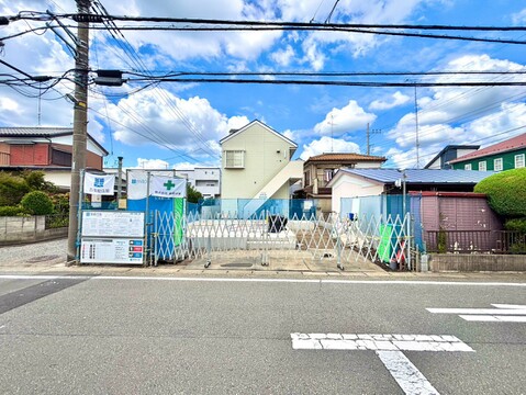 住宅街にある建物の外観と前面道路の様子