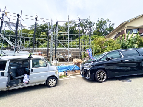 周辺に住宅が並ぶ閑静な住宅街の道路と駐車スペース