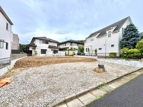 住宅地内の更地、周囲に戸建てが並ぶ静かな環境です