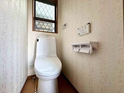 窓付きのトイレ壁面に収納棚あり