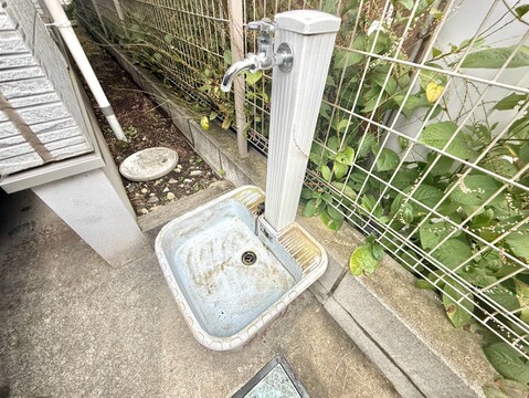 屋外に設置された洗面台とホース