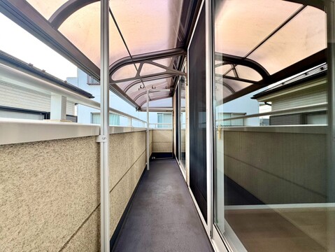 屋根付きの細長い通路と目隠し壁