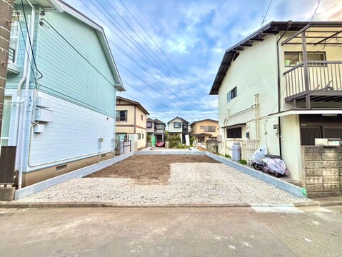 住宅街にある建物と前面道路の様子