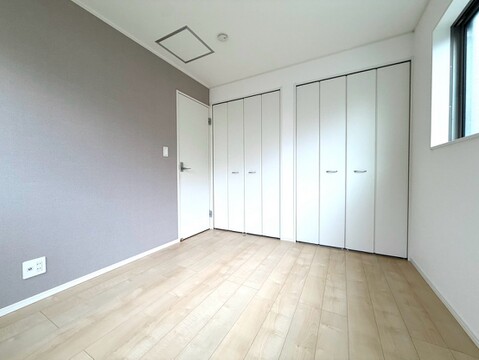 白い収納扉のある明るい洋室