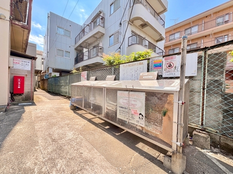 集合ポストと建物外観が見える住宅街の通路です