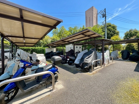 敷地内の駐輪スペースに複数のバイクが駐輪されている様子です
